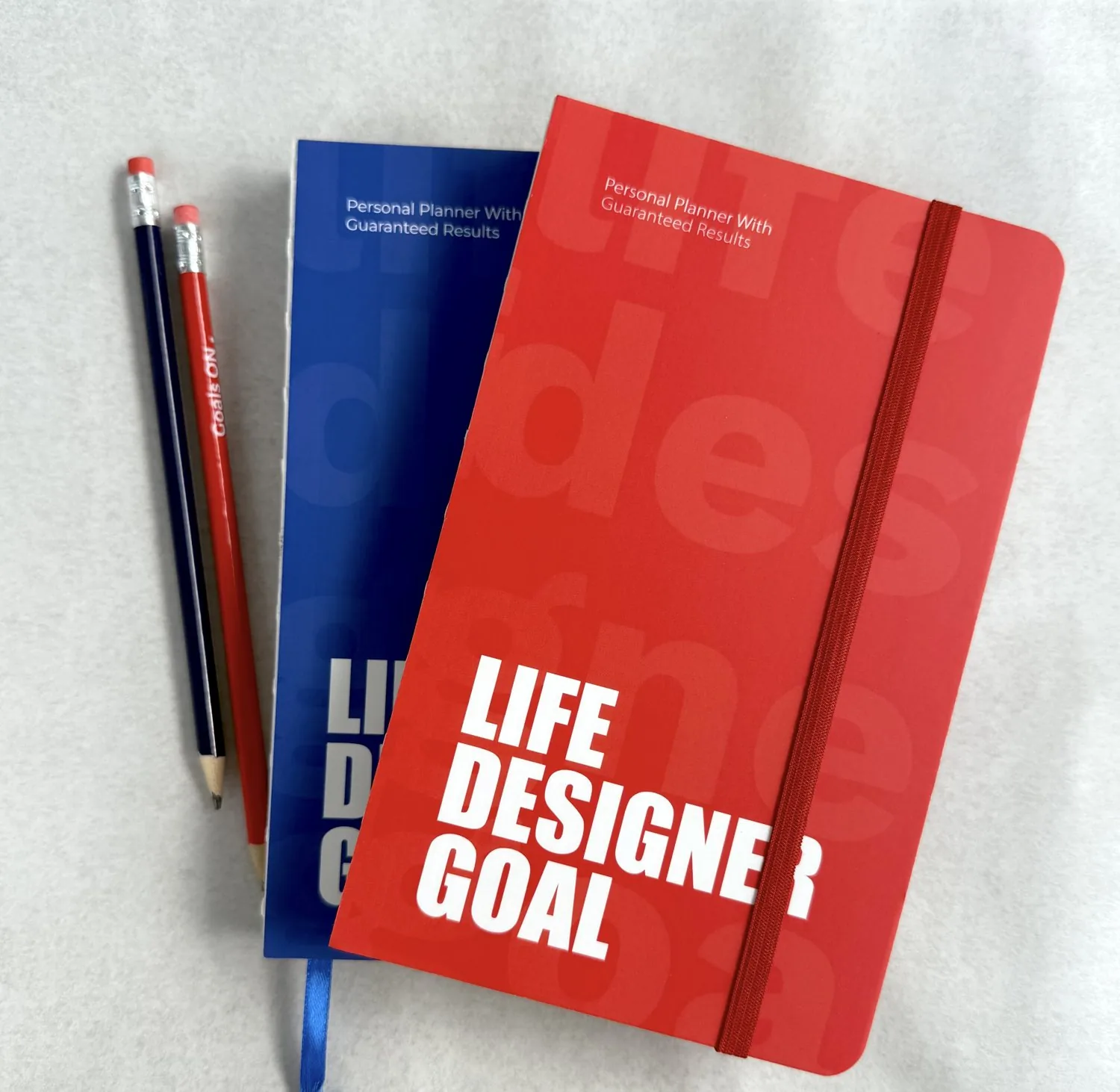 The Life Designer Goal planner, red and blue editions